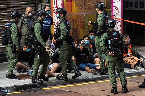 Police detain people as they patrol the area after protesters called for a rally in Hong Kong. (Photo| AFP)