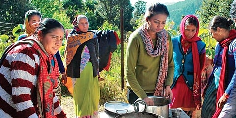 Kirti (centre) cooking with members of her self-help groups. (Photo| EPS)