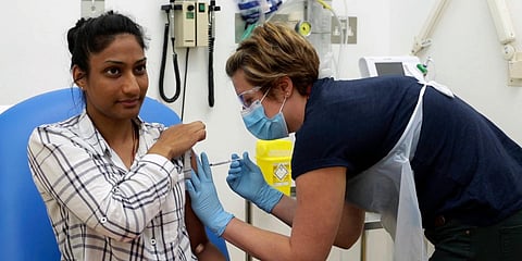A volunteer is injected with either an experimental COVID-19 vaccine or a comparison shot as part of the first human trials in the UK to test a potential vaccine, led by Oxford University. (File photo