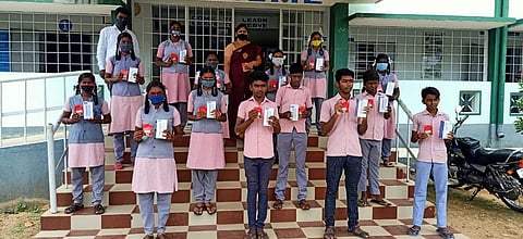 Students show their new smartphones with maths teacher K Bairavi at Elambalur Government Higher Secondary School Perambalur district. (Photo | Express)