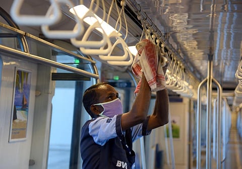 A worker wearing a face mask cleans a Metro coach as public transports prepare to resume from September 7, after more than 5 months, which were suspended due to COVID-19. (Photo | Martin Louis, EPS)