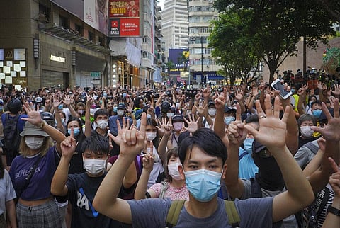 In this photo, protesters against the new national security law gesture with five fingers, signifying the 'Five demands - not one less,' on the anniversary of Hong Kong's handover (File Photo | AP)