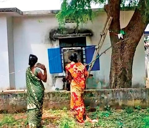 Family members of poacher P Kishan throw stones at the Khanapur Forest Range Office in Nirmal district on Monday