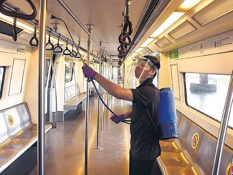 A DMRC staffer sanitises a coach in the city on Tuesday | PARVEEN NEGI