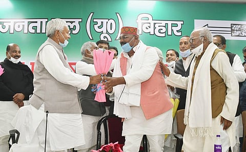CM Nitish Kumar and JD(U) National President RCP Singh greet newly-elected party state President Umesh Kushwaha during the second day of party state council meeting in Patna Sunday. (Photo | PTI)