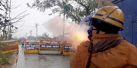 Police personnel use teargas to disperse the protesting farmers who gathered where Haryana CM Manohar Lal Khattar will hold Kisan Mahapanchayat, at Kaimla village in Karnal on Sunday. (Photo | ANI)
