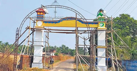 In the foreground is the old metal structure installed 20 years ago carrying the names of the masjid and the temple