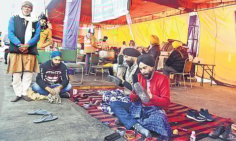 Volunteers polish shoes of farmers and visitors at a protest site in Delhi’s Ghazipur border on Monday | Parveen negi