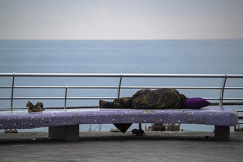 A homeless woman sleeps on a bench on the Mediterranean Sea corniche in Beirut, Lebanon. (Photo | AP)