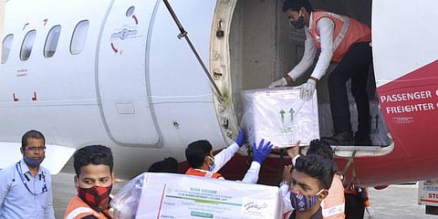 Workers unload from a plane the first consignment of Covishield vaccines, dispatched from Serum Institue of India. (Photo | ANI)