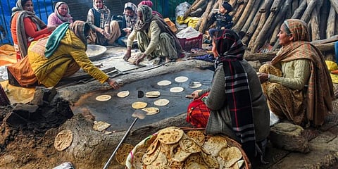Women prepare food for farmers and their supporters during the ongoing agitation against new farm laws, at Singhu border. (Photo | PTI)