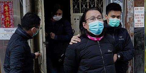 District councillor and lawyer Daniel Wong Kwok-tung (C) is escorted by police outside his office after police search in Hong Kong. (Photo| AP)