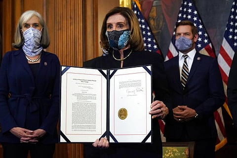 House Speaker Nancy Pelosi of Calif., displays the signed article of impeachment against President Donald Trump. (Photo | AP)