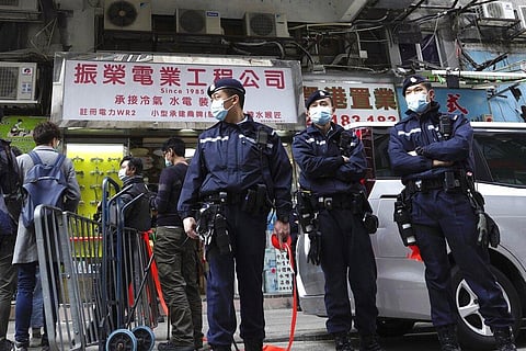 Police officers stand guard outside office of District councillor and lawyer Daniel Wong Kwok-tung, while police search in Hong Kong. (Photo | AP)