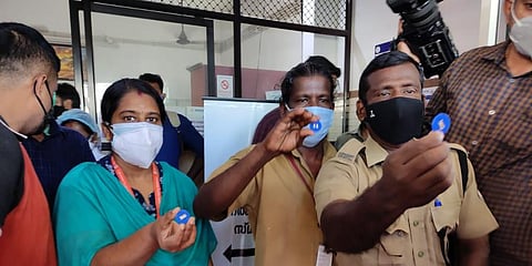 Health workers showing their tokens before getting vaccinated at Ernakulam Government General Hospital. (Photo | A Sanesh, EPS)