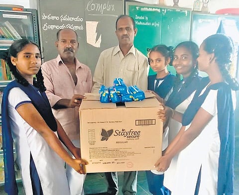Mavuluri Suresh Babu distributing sanitary pads to students at a government high school in Chillakur mandal of Nellore district. (Photo | Express)