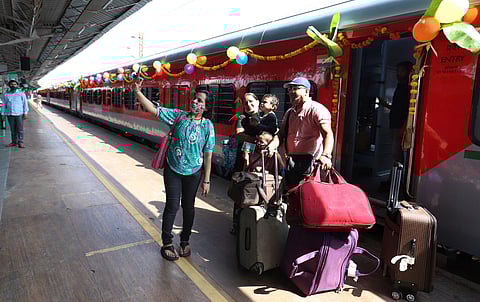 Passengers take a selfie in front of the new train bound for Kevadiya in Gujarat on Sunday. PM Narendra Modi had earlier flagged off the train. (Photo | Ashwin Prasath, EPS)