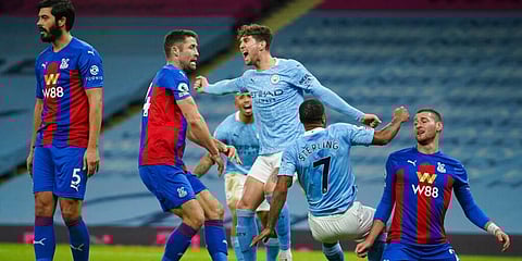 Manchester City's John Stones (C) celebrates after scoring his side's opening goal during an English Premier League match against Crystal Palace. (Photo | AP)