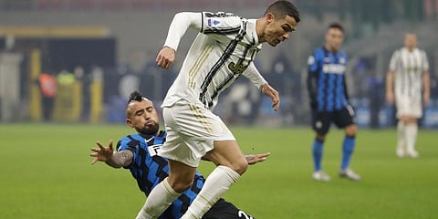 Juventus' Cristiano Ronaldo is tackled by Inter Milan's Arturo Vidal during Serie A. (Photo | AP)