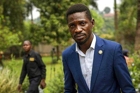 Uganda's leading opposition challenger Bobi Wine walks back to his residence after giving a press conference outside Kampala, Uganda. (Photo | AP)