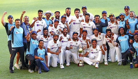 Indian players celebrate with their trophy after defeating Australia by three wickets on the final day of the fourth cricket test at the Gabba, Brisbane. (Photo | AP)