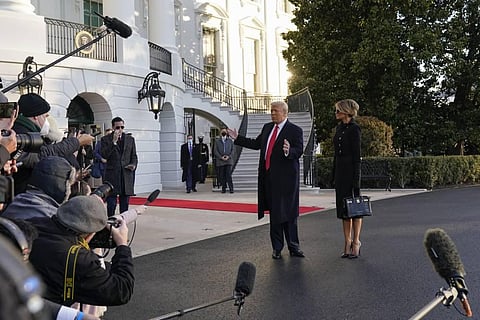 President Donald Trump and first lady Melania Trump stop to talk with the media as they walk to board Marine One on the South Lawn of the White House. (Photo | AP)