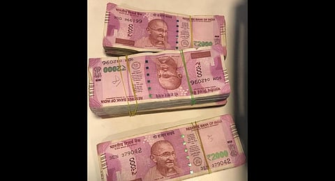 A few of the note bundles seized from a passenger on Wednesday at Bengaluru airport. (Photo | Special Arrangement)