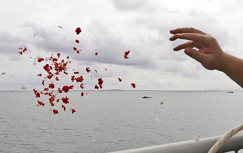 A relative throws flowers into the Java Sea where Sriwijaya Air flight SJ-182 crashed on Jan. 9 killing all of its passengers. (Photo | AP)