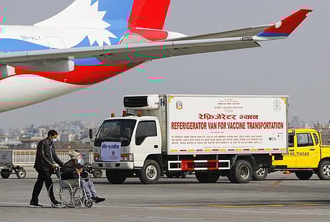 A van stands parked waiting to transport AstraZeneca/Oxford University vaccines, manufactured under license by Serum Institute of India, at Tribhuwan International Airport in Kathmandu. (Photo | AP)