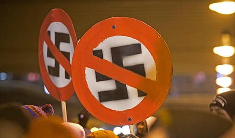 This file photo taken on February 13, 2013 shows left-wing demonstrators holding signs with crossed out swastikas to protest against a far-right march in Dresden, eastern Germany. (Photo | AFP)