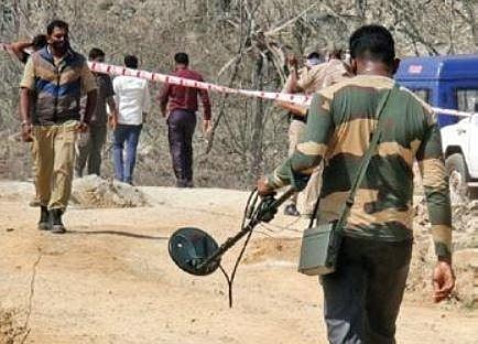 Bomb squad personnel scan the blast site on the outskirts of Shivamogga city on Friday | SHIMOGA NANDAN