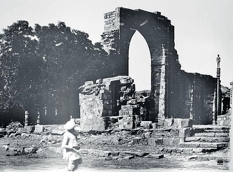 A young man on top of the iron pillar in Qutub Minar complex. (Photo | ASI)
