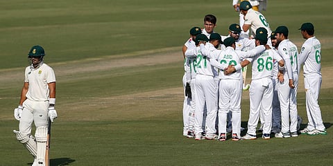 South Africa's batsman Aiden Markram (L) walks back as Pakistan's Shaheen Afridi (C) celebrates with teammates after taking the wicket during 1st Test match. (Photo| AP)