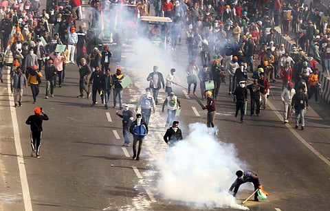 Police use tear gas on protesting farmers during a tractor rally on 72nd Republic Day at Akshardham Ring Road in New Delhi. (Photo | PTI)