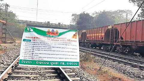A banner put up by protestors on rail track during the economic blockade in Talcher. (Photo | EPS)