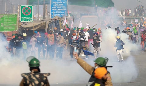 Police uses tear gas to disperse farmers attempting to break barricades at Ghazipur border during their Kisan Gantantra Parade on the occasion of 72nd Republic Day. (Photo | Shekhar Yadav, EPS)