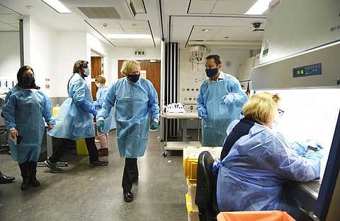 Britain PM Boris Johnson at the Lighthouse Laboratory, used for processing polymerase chain reaction samples for coronavirus in Glasgow. (Photo | AP)