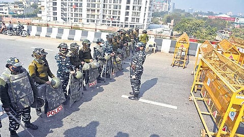 Security personnel stand guard near barricades set up across a road at the Ghazipur border in New Delhi on Wednesday. (Photo | Parveen Negi, EPS)