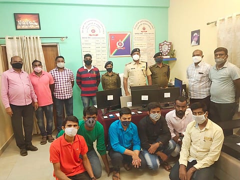 Railway Protection Force personnel with the six of the touts (seated) arrested at Yesvantpur for booking rail tickets illegally. (Photo | EPS)