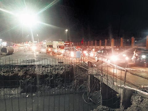 Vehicles taking the narrow pathway by the side of the culvert construction work underway near Kaiveli junction | Express
