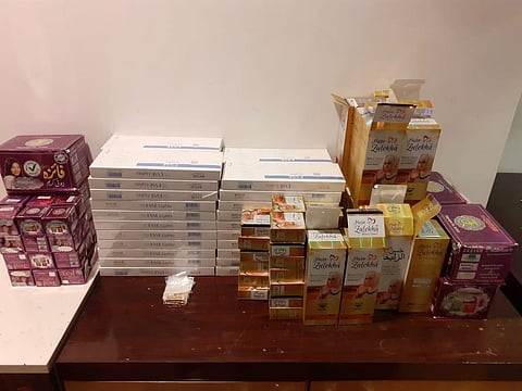Cigarette sticks and beauty cream bottles seized from.the passengers (Photo | Special arrangement)
