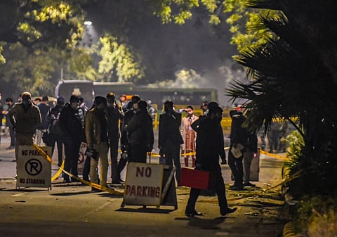 Security personnel inspect the area after a low intensity blast outside the Israeli Embassy, in New Delhi. (Photo | PTI)