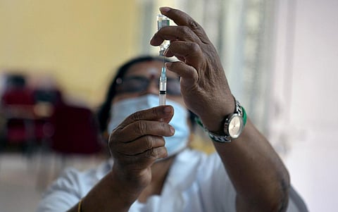 A health worker checks a syringe during a vaccination drive at  KC General Hospital in Bengaluru. (Photo | Meghana Sastry, EPS)