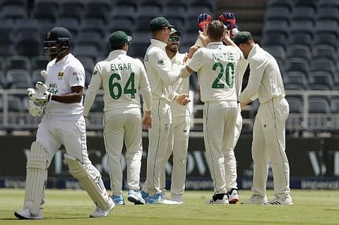 South Africa's Anrich Nortje (2nd R) celebrates with teammates after the dismissal of Sri Lanka's captain Dimuth Karunaratne during the first day of the second Test cricket match (Photo | AFP)