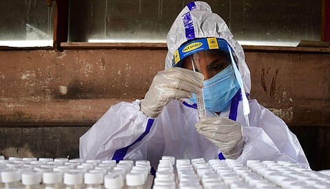 Helath workers collecting samples of people at Mejstic bus stand in Bengaluru. (Photo | hriram BN, EPS)