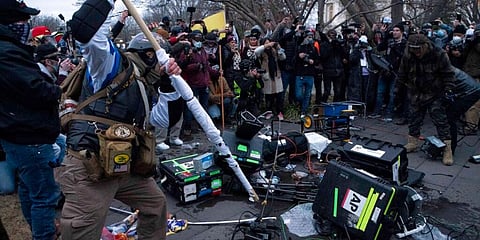 Demonstrators break TV equipment outside the US Capitol. (Photo | AP)