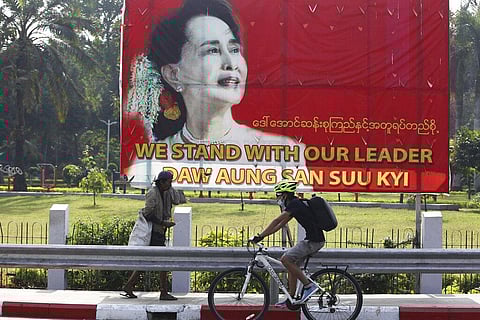 A cyclist bikes past a signboard with an image of Myanmar leader Aung San Suu Kyi, in Yangon, Myanmar Friday, Jan. 29, 2021. (Photo | AP)