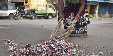 A sanitation worker cleaning the road with crackers' waste. (File Photo | P Jawahar, EPS)