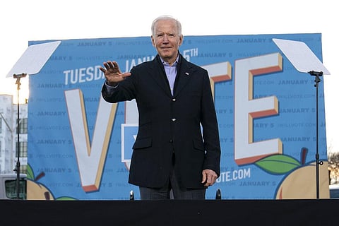 President-elect Joe Biden waves from the stage as he campaigns for for Georgia Democratic candidates for U.S. Senate, Rev. Raphael Warnock and Jon Ossoff in Atlanta. (Photo | AP)