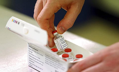 Doses of the COVID-19 vaccine developed by Oxford University and U.K.-based drugmaker AstraZeneca are checked as they arrive at the Princess Royal Hospital in Haywards Heath. (Photo | AP)